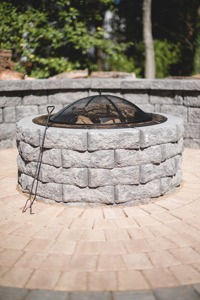 Inspiration for a small transitional backyard brick patio remodel in Richmond with a fire pit and no cover