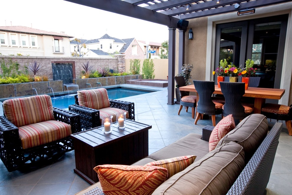 Small bohemian back patio in Los Angeles with a water feature, tiled flooring and a pergola.