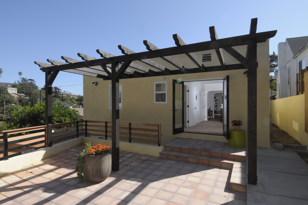 Mid-sized tuscan backyard tile patio photo in Los Angeles with a pergola
