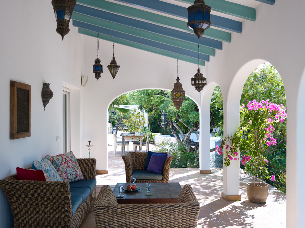 Idee per un patio o portico mediterraneo di medie dimensioni con piastrelle e una pergola
