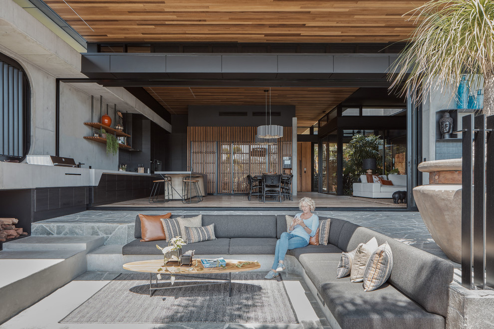 Inspiration for a contemporary back patio in Sydney with tiled flooring and a roof extension.