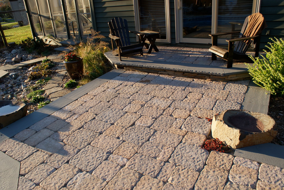 Photo of a large traditional back patio in Minneapolis with brick paving and no cover.