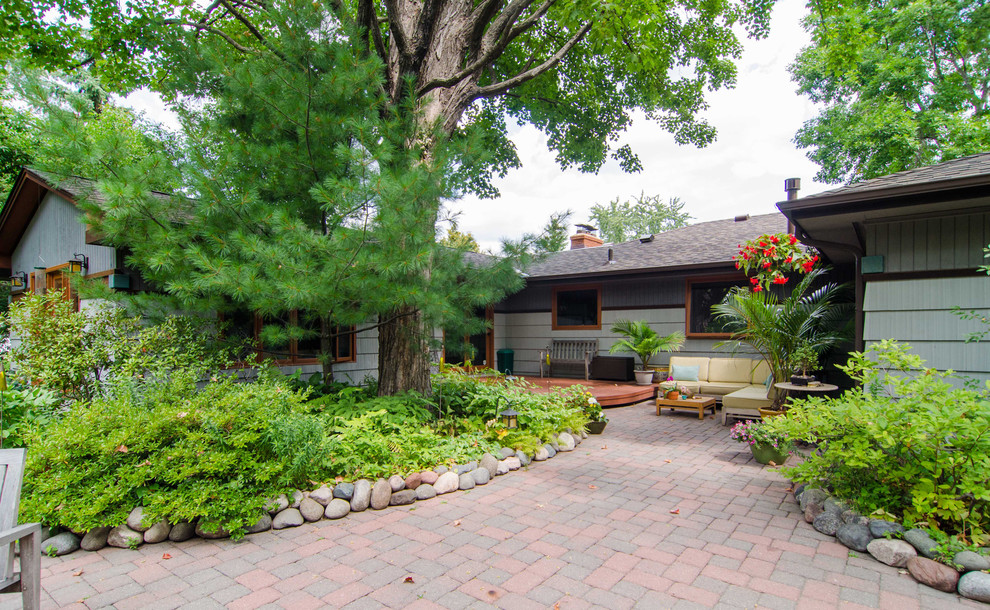Photo of a large world-inspired back patio in Minneapolis with concrete paving and no cover.