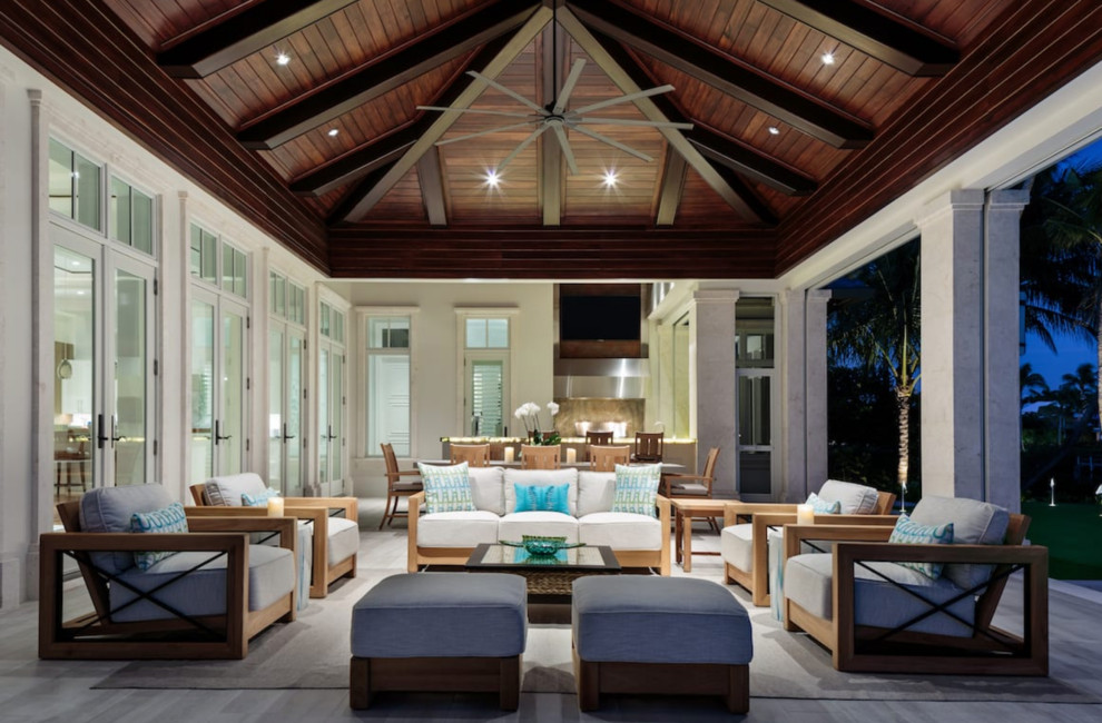Inspiration for a large mediterranean backyard patio kitchen remodel in Miami with a roof extension