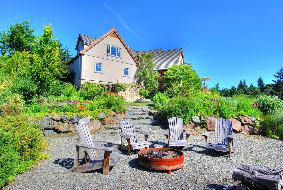 Large elegant backyard gravel patio photo in Seattle with a fire pit and no cover
