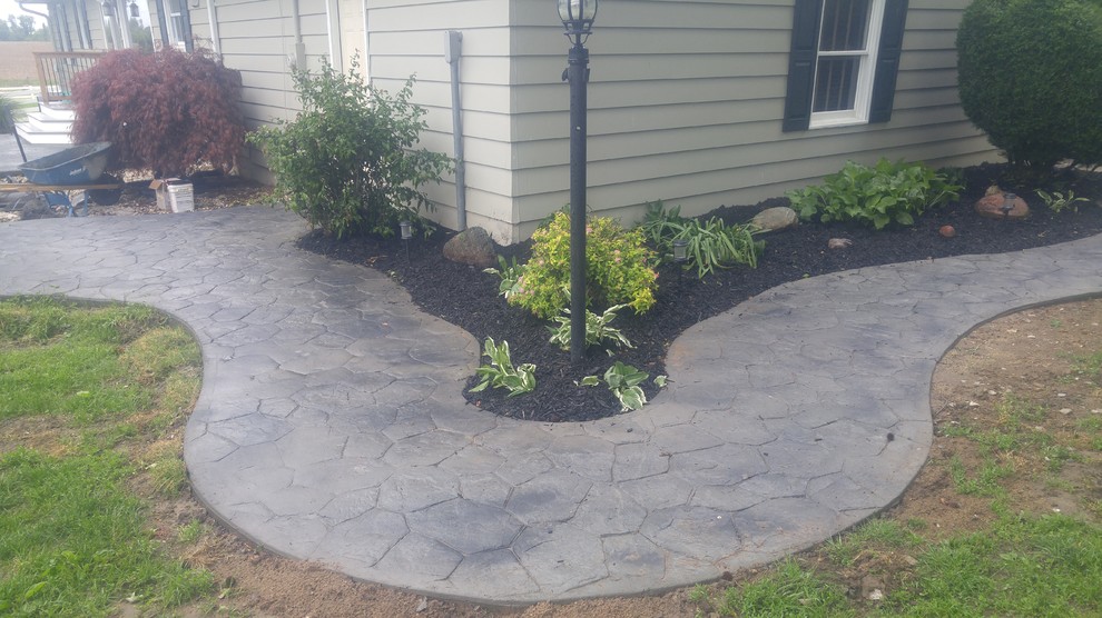 Huge cottage side yard stamped concrete patio photo in St Louis