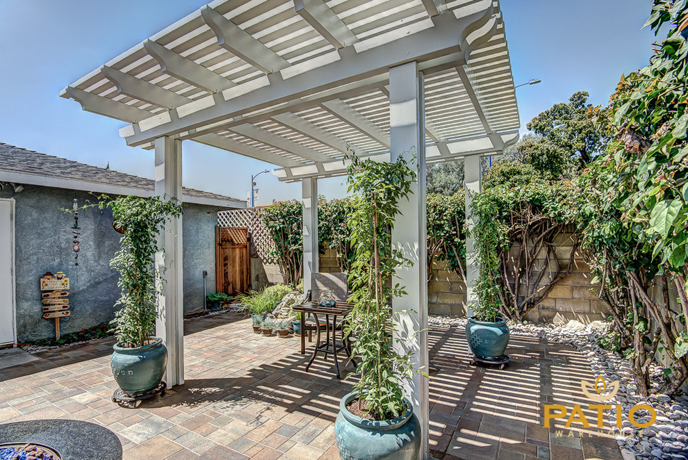 Mountain style backyard concrete paver patio photo in Los Angeles with a fire pit and a pergola
