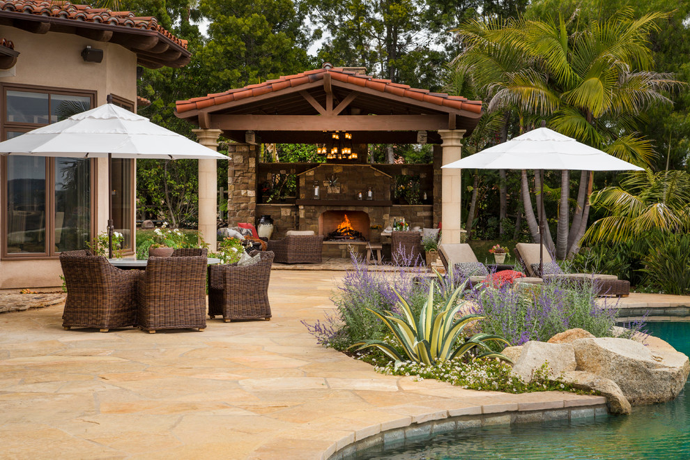 Patio - large mediterranean backyard tile patio idea in San Diego with a fire pit and a gazebo