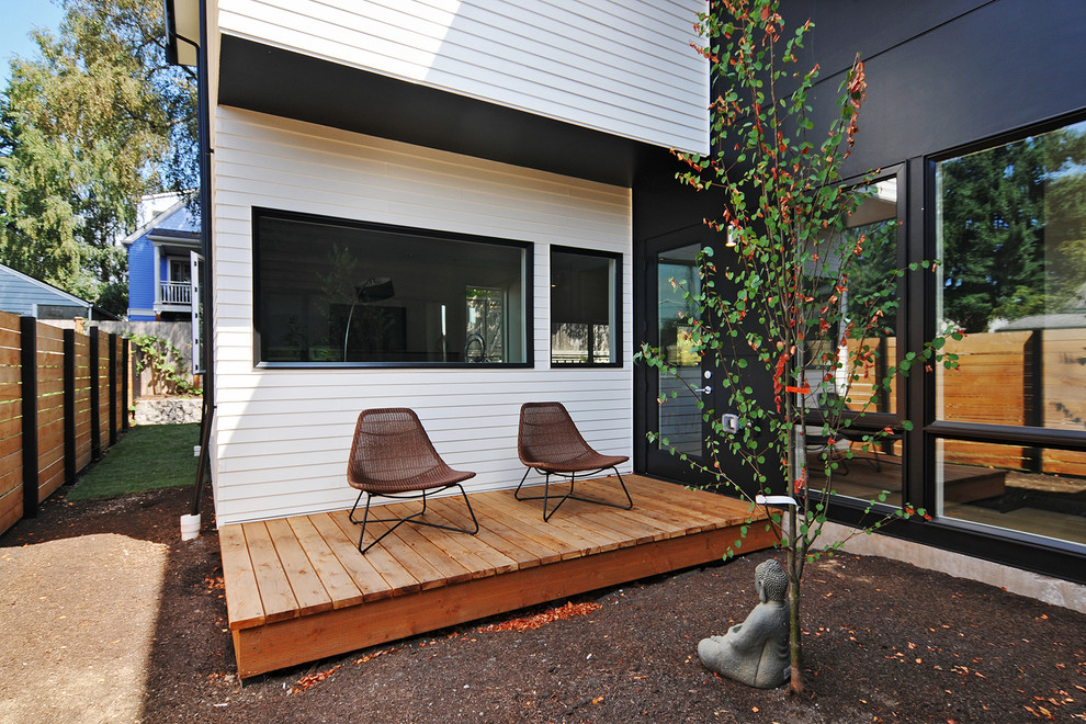 Inspiration for a small retro side patio in Seattle with an awning.