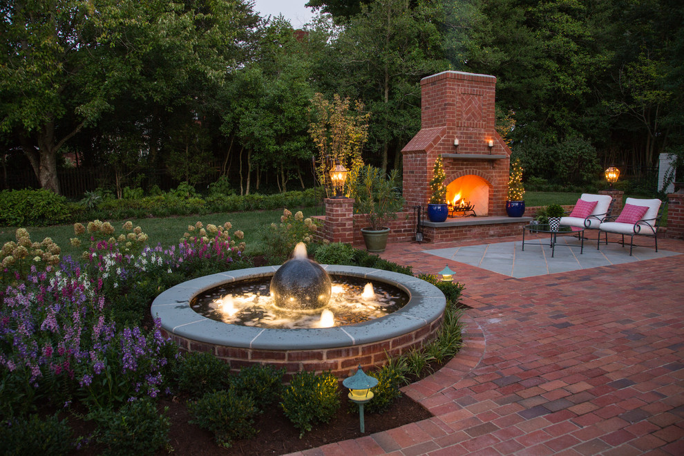 Patio fountain - large traditional backyard brick patio fountain idea in St Louis