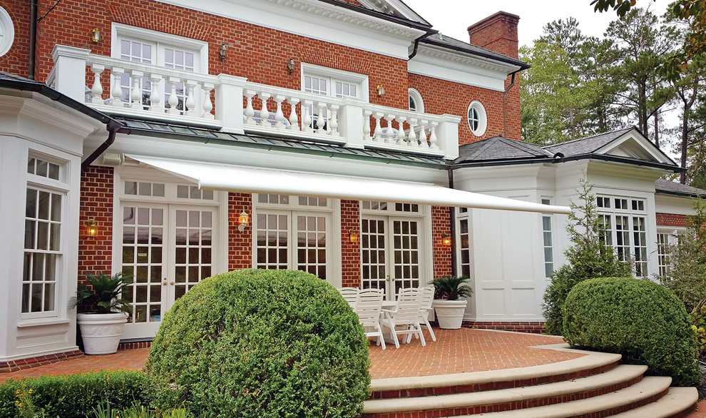 Elegant Series G250 on brick home Traditional Patio Portland Maine by NuImagePro Awnings
