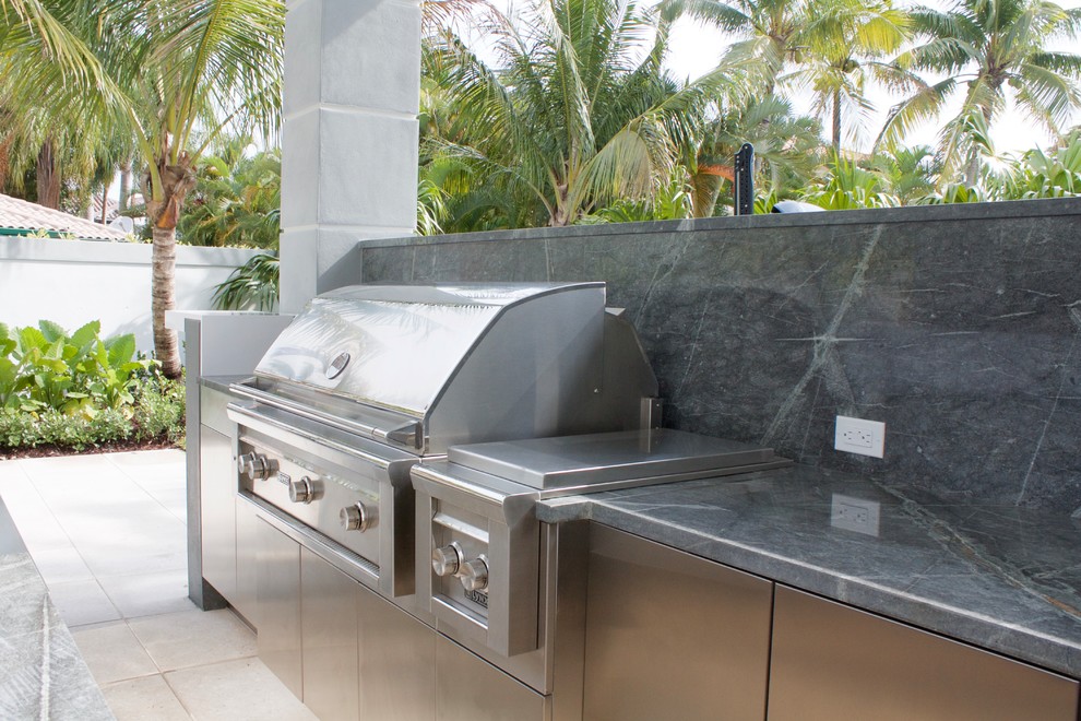 Design ideas for a medium sized modern back patio in Miami with an outdoor kitchen, concrete paving and a gazebo.
