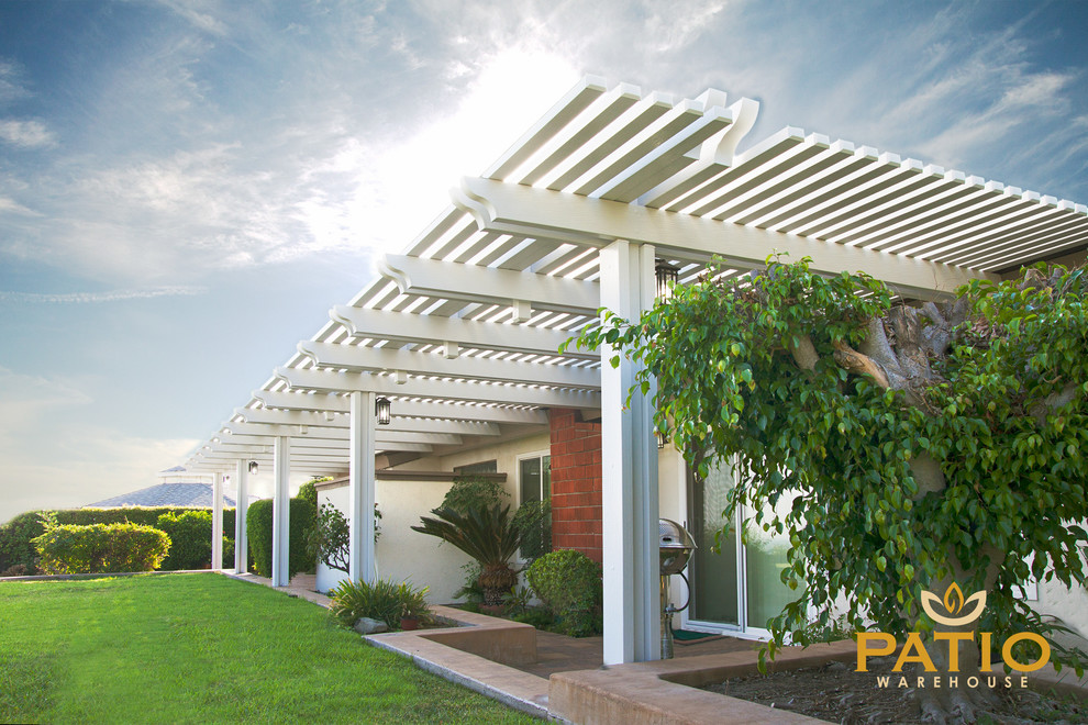 Inspiration for a timeless backyard concrete paver patio remodel in Orange County with a pergola