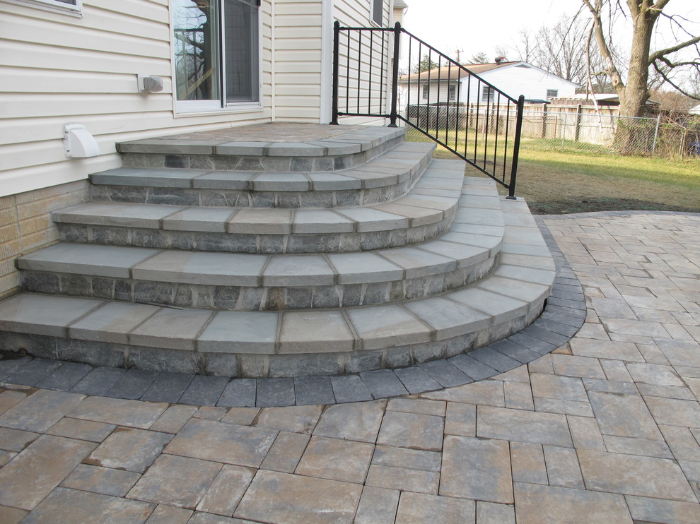 Inspiration for a mid-sized timeless backyard stone patio remodel in Baltimore with a fire pit and no cover