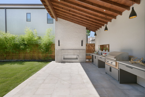 Stainless steel outdoor cabinet island beside polymer storage units