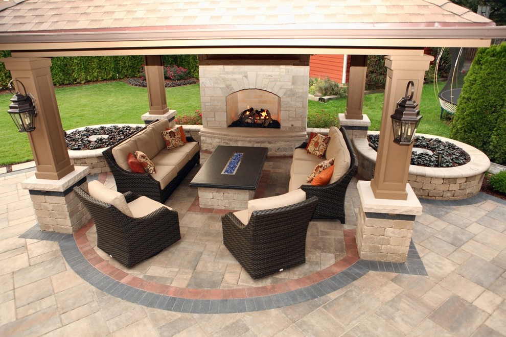 Inspiration for a traditional back patio in Chicago with an outdoor kitchen, brick paving and a pergola.