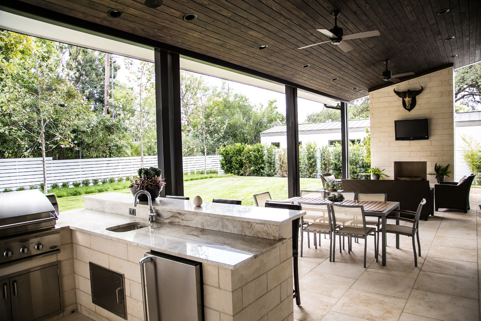 Inspiration for a timeless backyard patio kitchen remodel in Austin with a roof extension