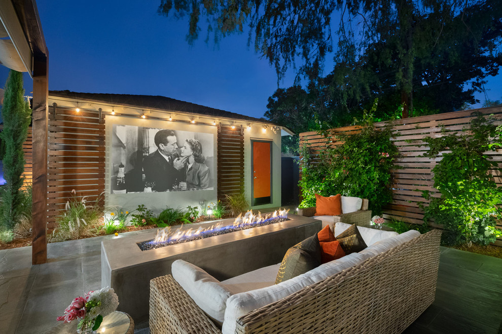 Example of a transitional patio design in Los Angeles with a fire pit and no cover
