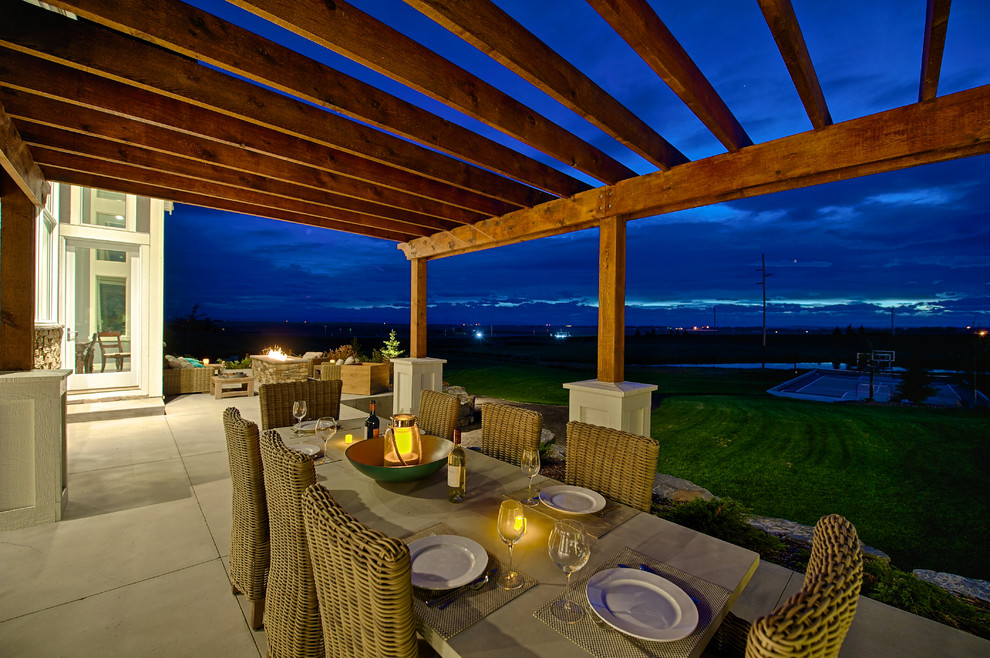 Photo of a medium sized classic back patio in Calgary with a pergola.