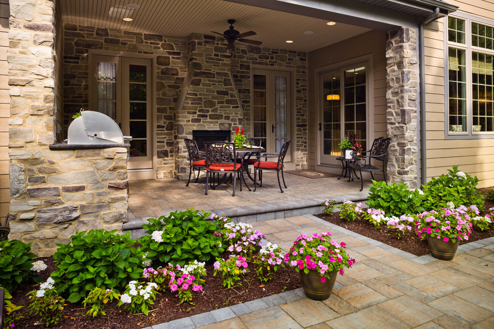 Design ideas for a classic back patio with brick paving and a roof extension.