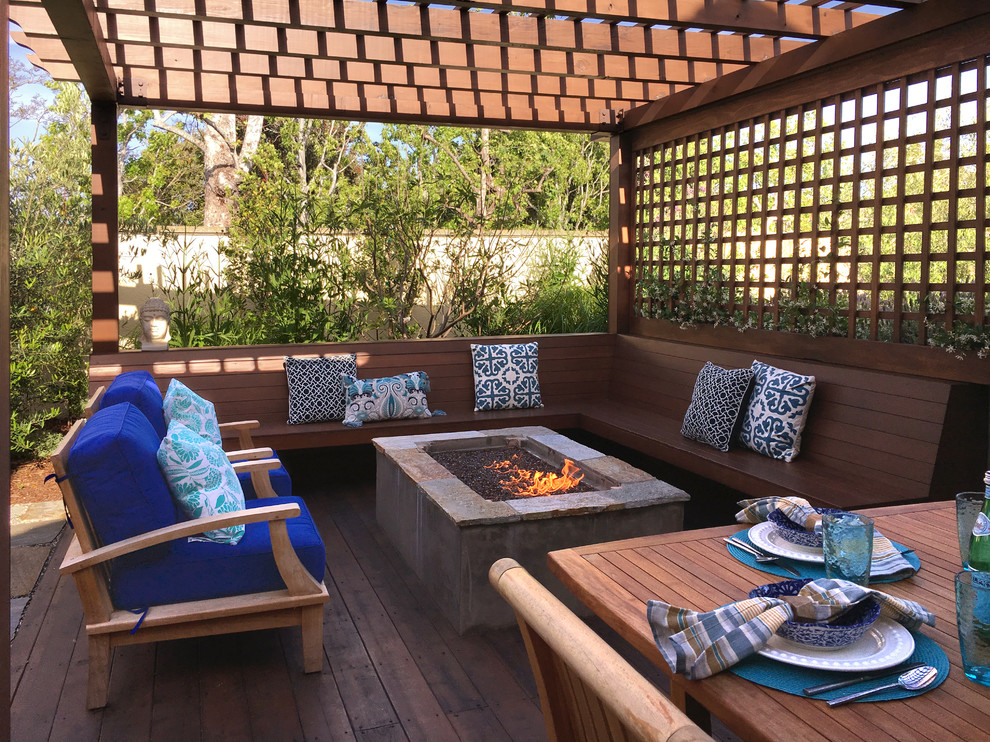 Photo of a medium sized contemporary back patio in Los Angeles with a fire feature and natural stone paving.