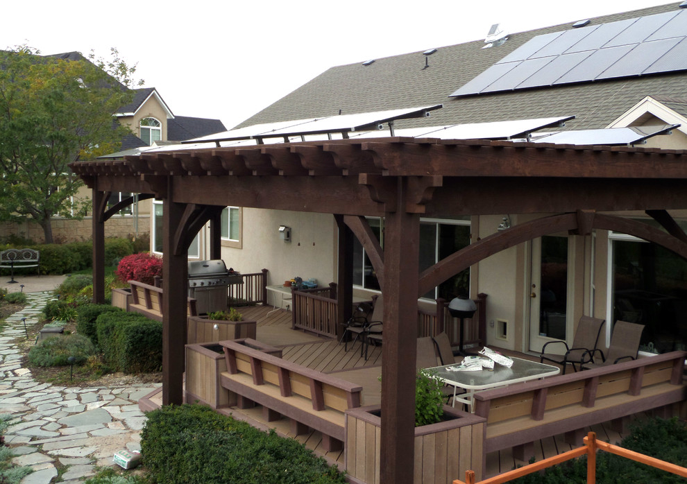 Patio - mid-sized traditional backyard patio idea in Salt Lake City with a roof extension and decking