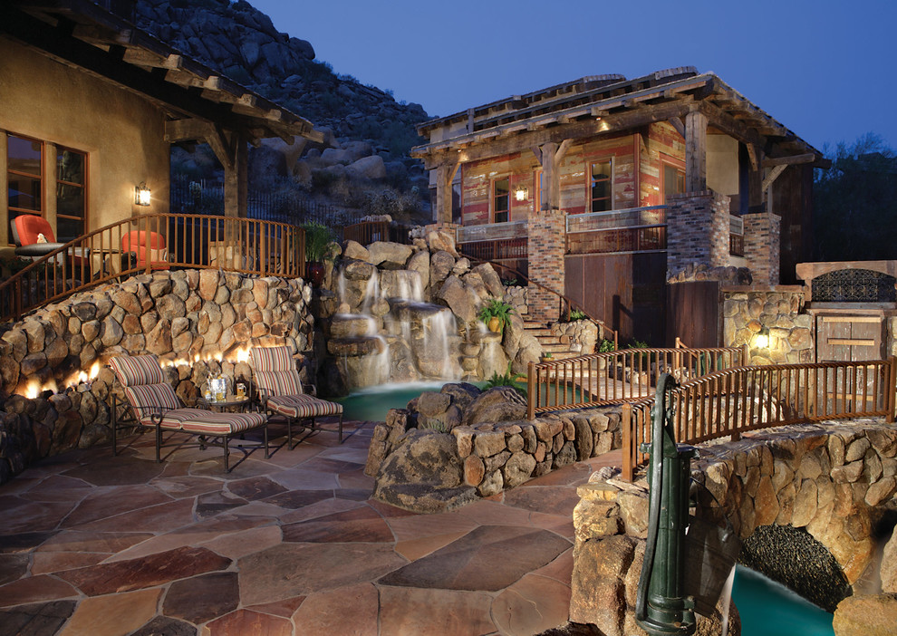 Design ideas for a medium sized rustic patio in Phoenix with a water feature, natural stone paving and no cover.