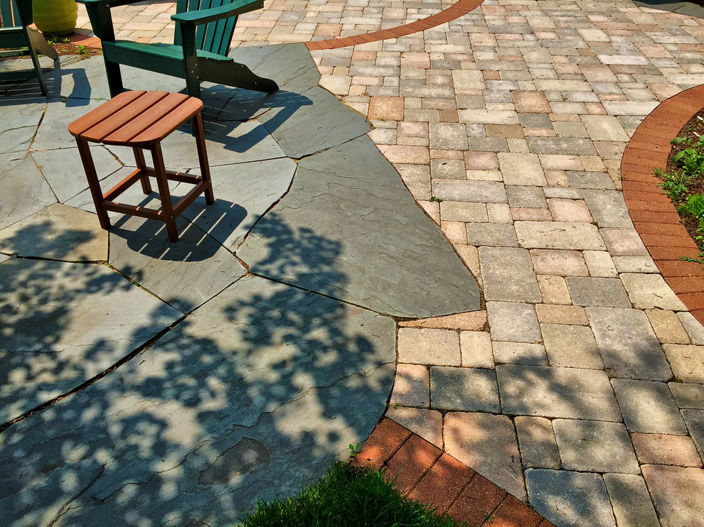 Inspiration for a small traditional side patio in Chicago with brick paving.