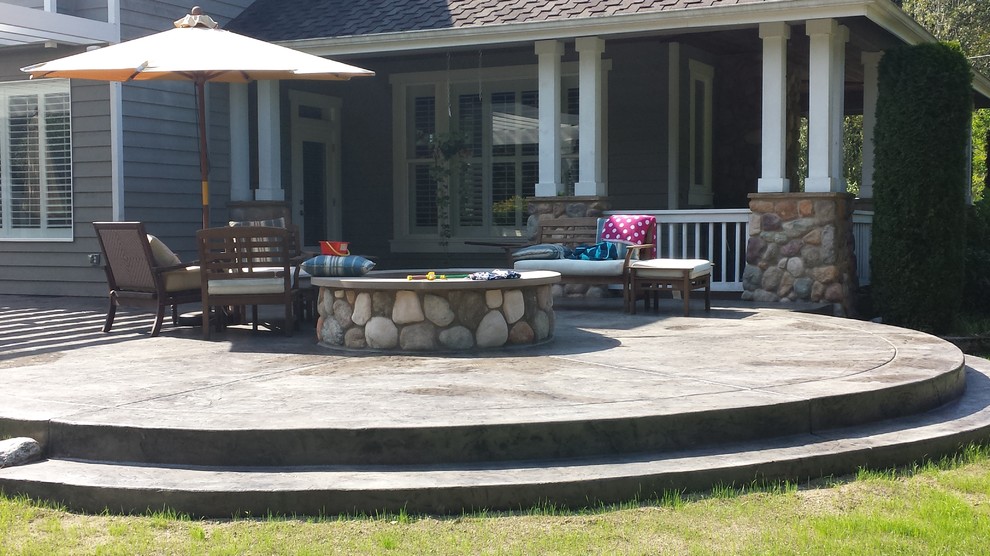 Ejemplo de patio de estilo americano grande en patio trasero con cocina exterior, suelo de hormigón estampado y pérgola