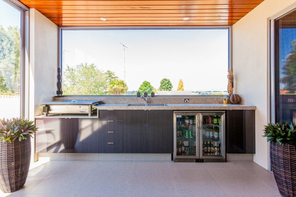 Стильный дизайн: двор среднего размера на заднем дворе в современном стиле с покрытием из плитки, навесом и зоной барбекю - последний тренд