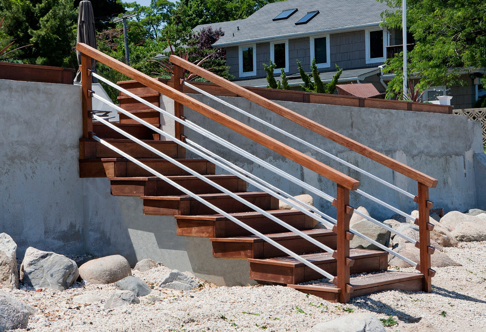 Photo of a beach style patio steps in New York with decking.