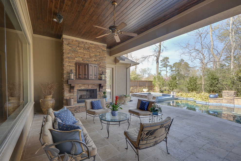 Mid-sized mountain style backyard tile patio photo in Houston with a fire pit and a roof extension