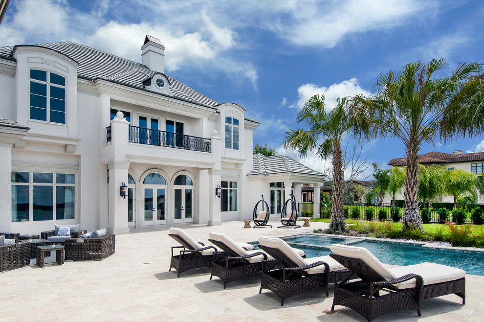 Inspiration for a timeless backyard stone patio remodel in Tampa with no cover