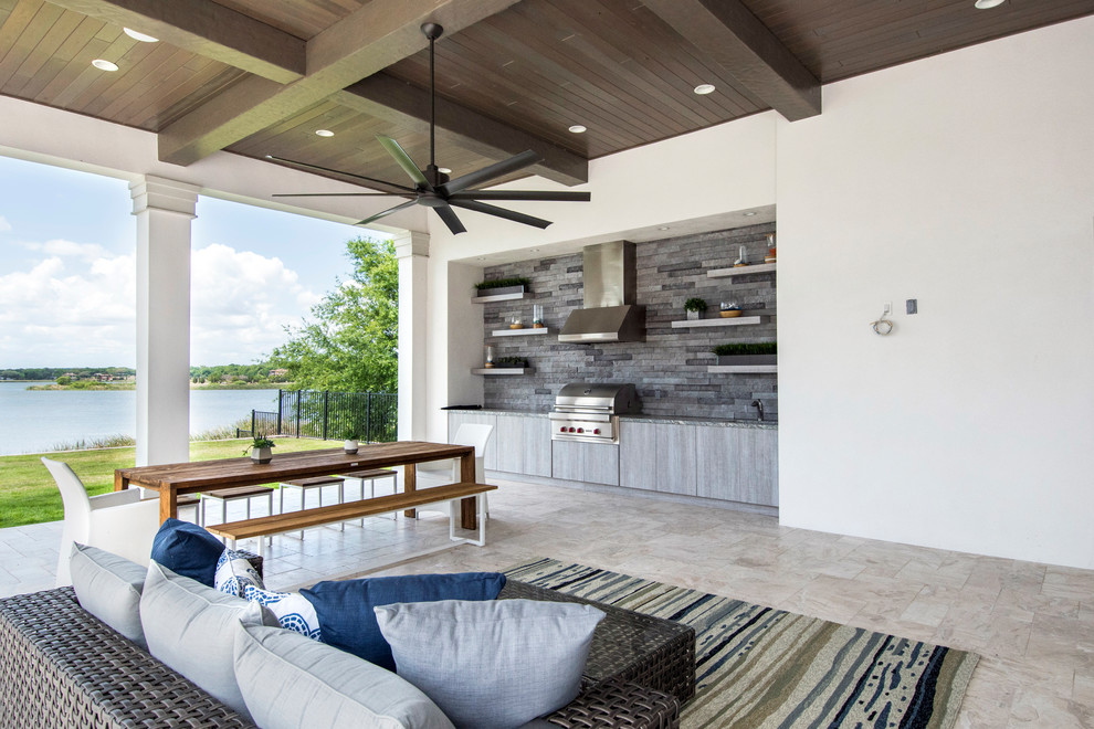 Example of a classic backyard stone patio design in Tampa with a roof extension