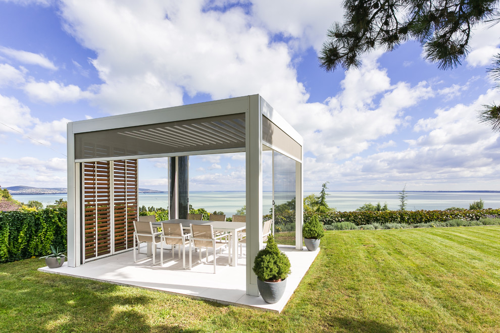 This is an example of a contemporary back patio in Other with a gazebo.
