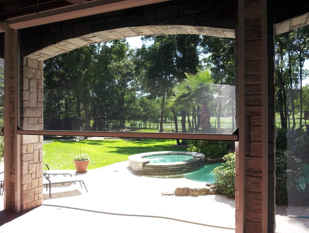 Example of a mid-sized classic backyard concrete patio design in Dallas with a roof extension