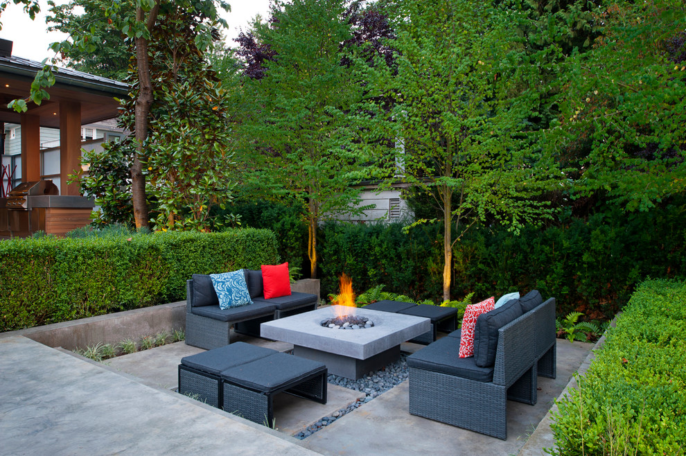 Photo of a contemporary patio in Vancouver with a fire feature and no cover.
