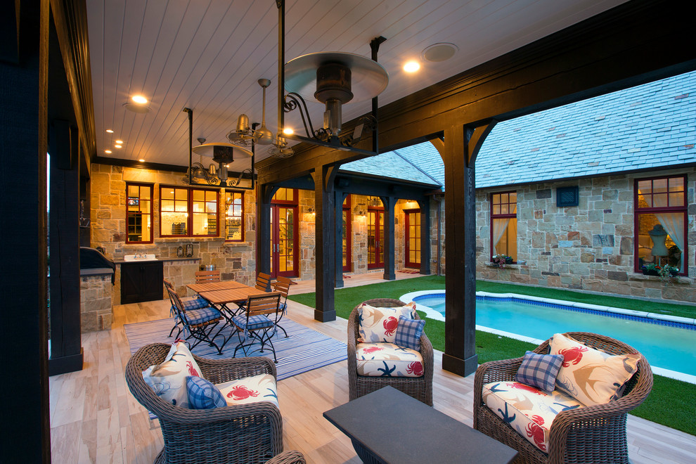 Exemple d'une terrasse en bois arrière tendance de taille moyenne avec une extension de toiture et une cuisine d'été.