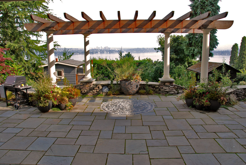 Idee per un patio o portico chic con una pergola, pavimentazioni in pietra naturale e scale