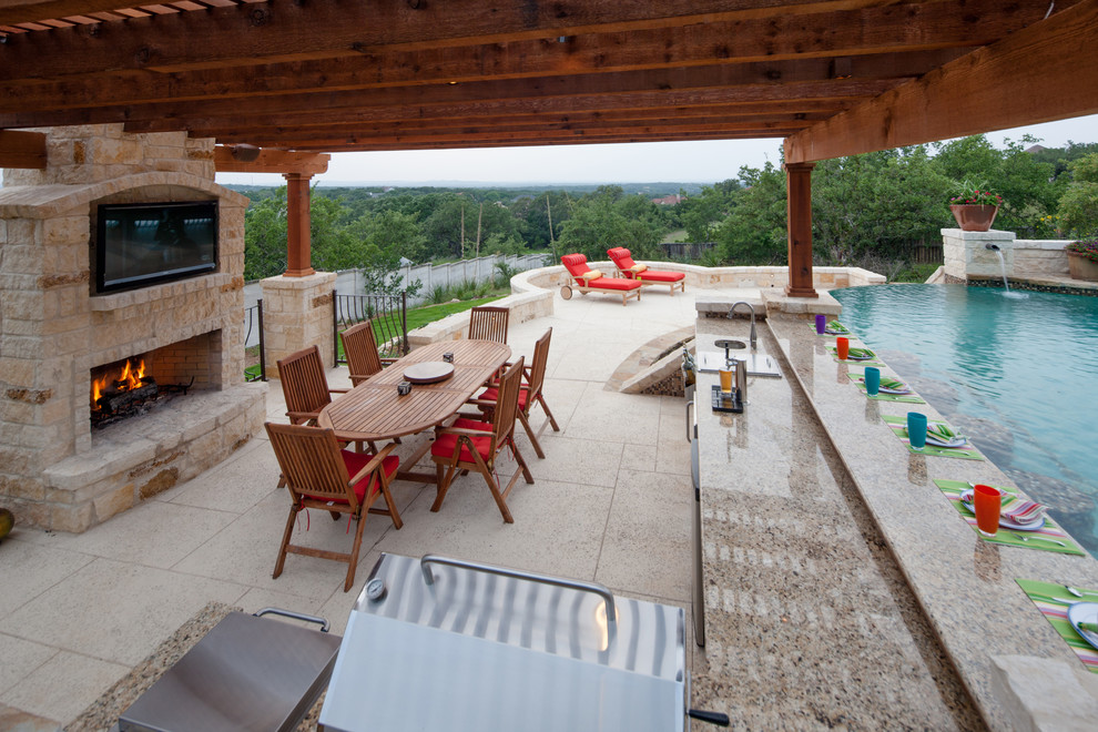 Photo of a large mediterranean back patio in Austin with an outdoor kitchen and a pergola.