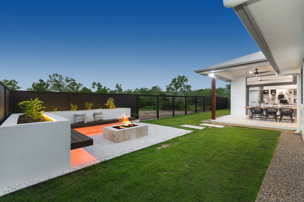 Design ideas for a large modern back patio in Townsville with a fire feature, concrete paving and a roof extension.