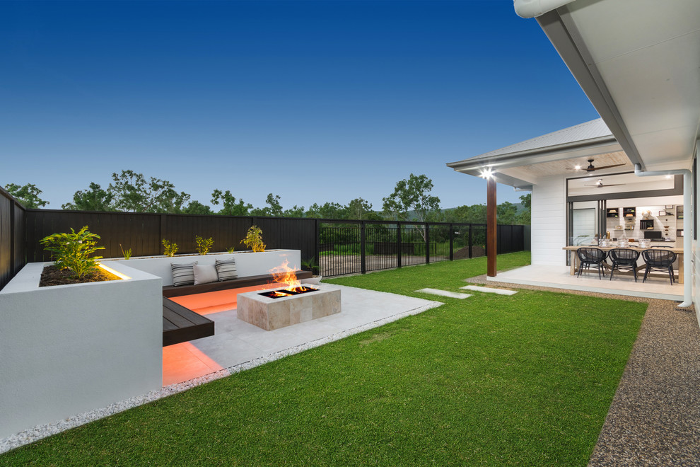 Inspiration for a large modern back patio in Townsville with a fire feature, concrete paving and a roof extension.