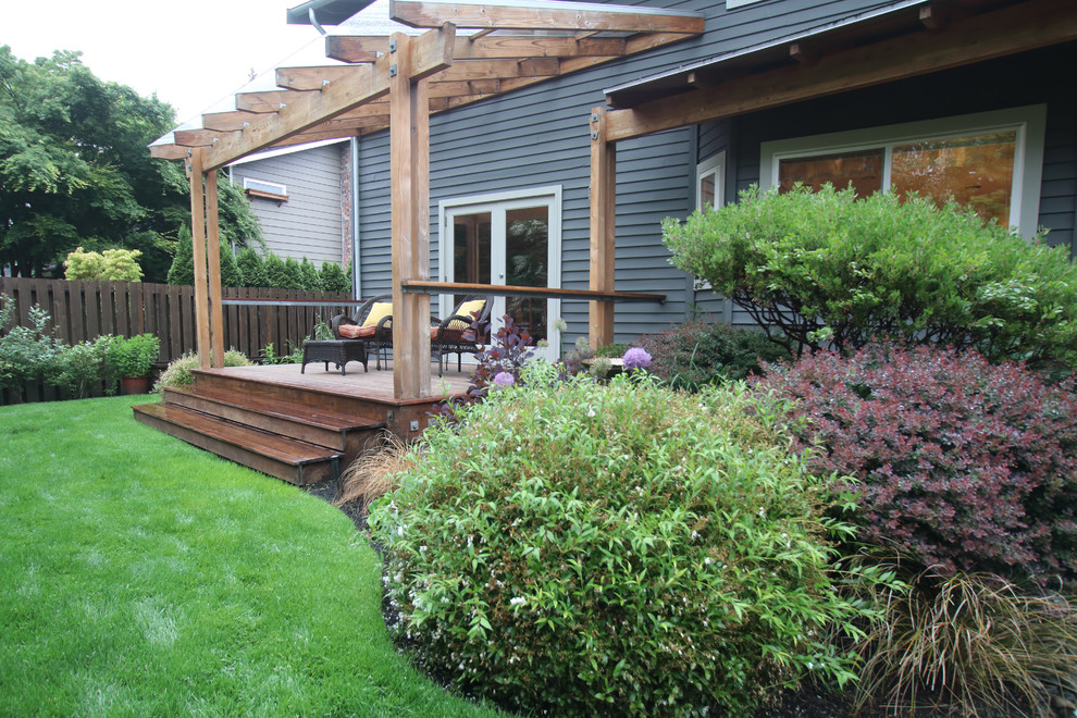 Medium sized contemporary back patio in Seattle with decking and a pergola.