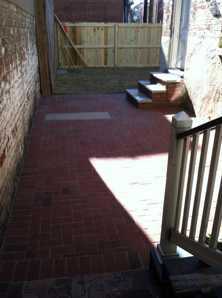 Esempio di un piccolo patio o portico dietro casa con pavimentazioni in mattoni e nessuna copertura