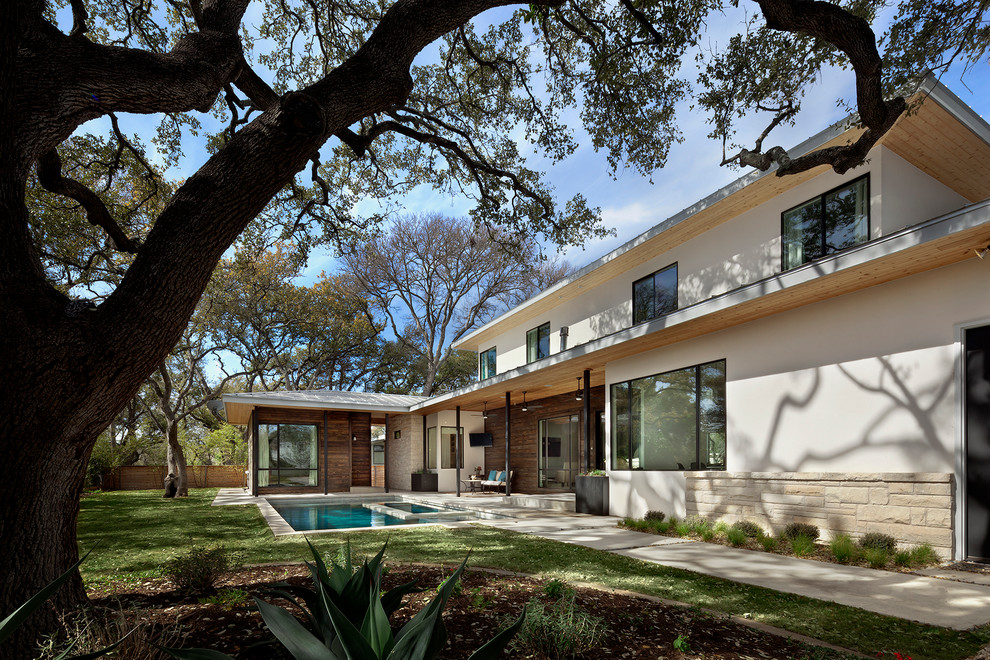 Mittelgroßer, Überdachter Moderner Patio hinter dem Haus mit Betonplatten in Austin
