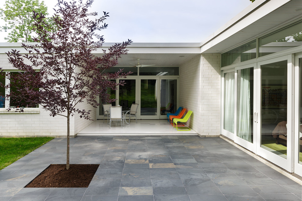 This is an example of a large contemporary patio in Cincinnati.