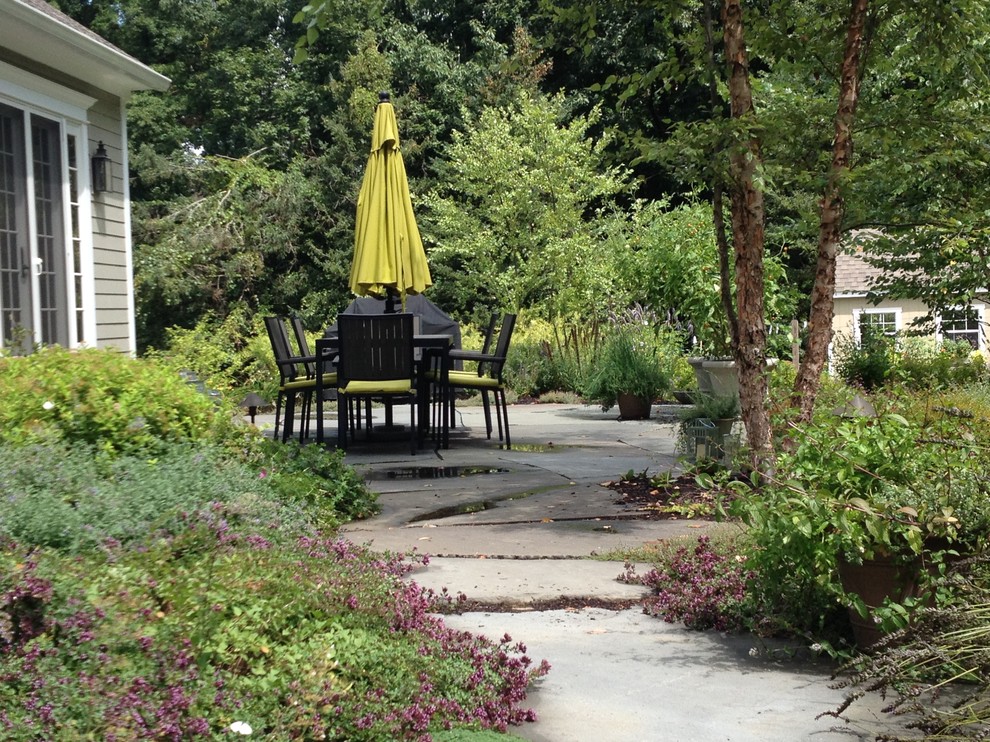 Esempio di un patio o portico country dietro casa con pavimentazioni in pietra naturale