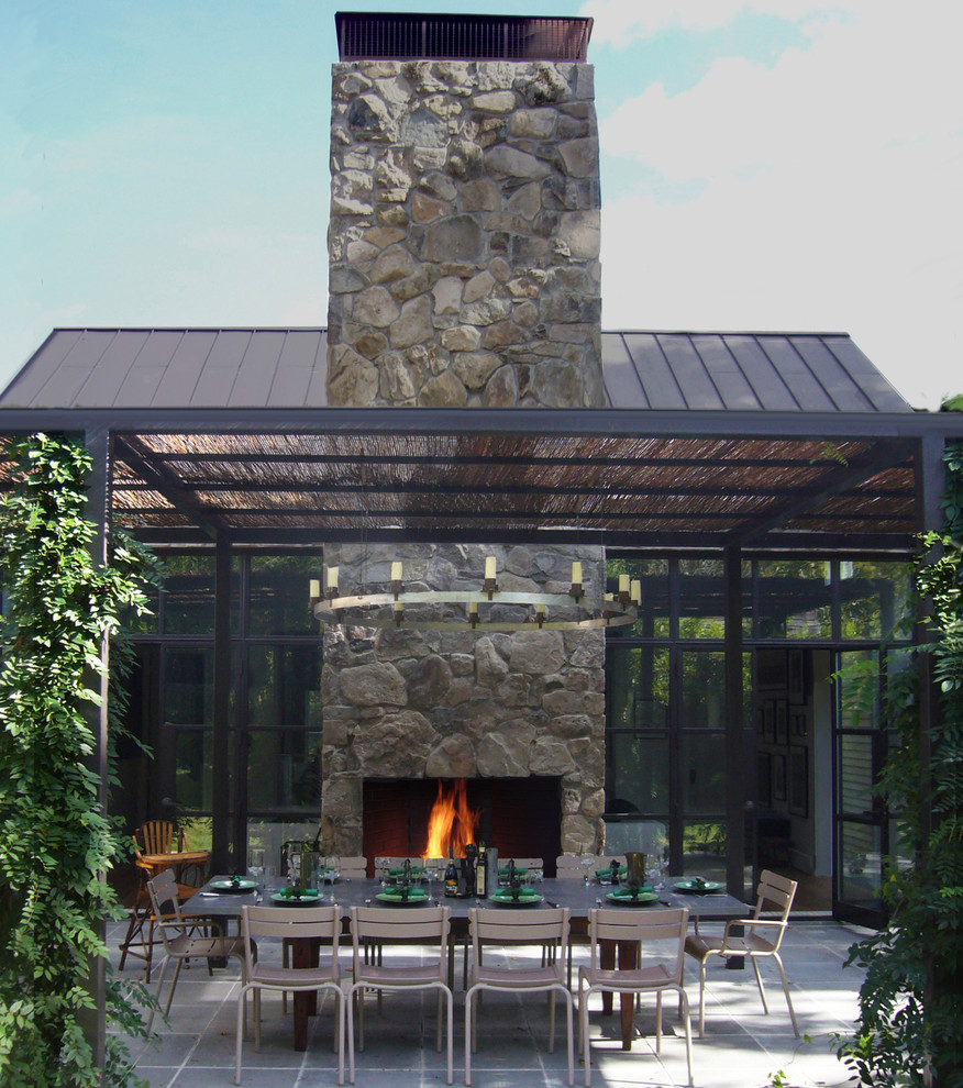 Cottage patio photo in New York with a fire pit and a pergola