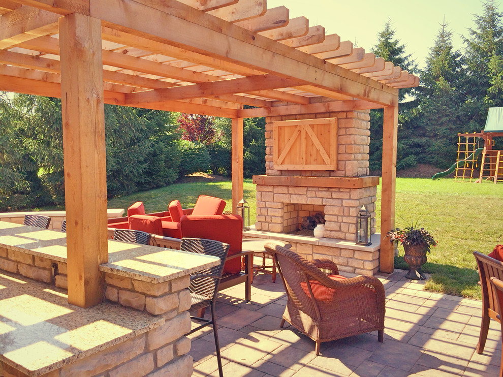 Large cottage backyard concrete paver patio photo in Cincinnati with a fire pit and a pergola