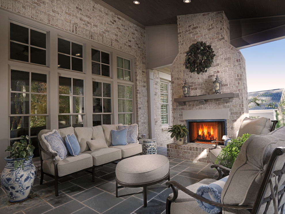 Inspiration for a medium sized traditional back patio in Atlanta with a fire feature, brick paving and a roof extension.